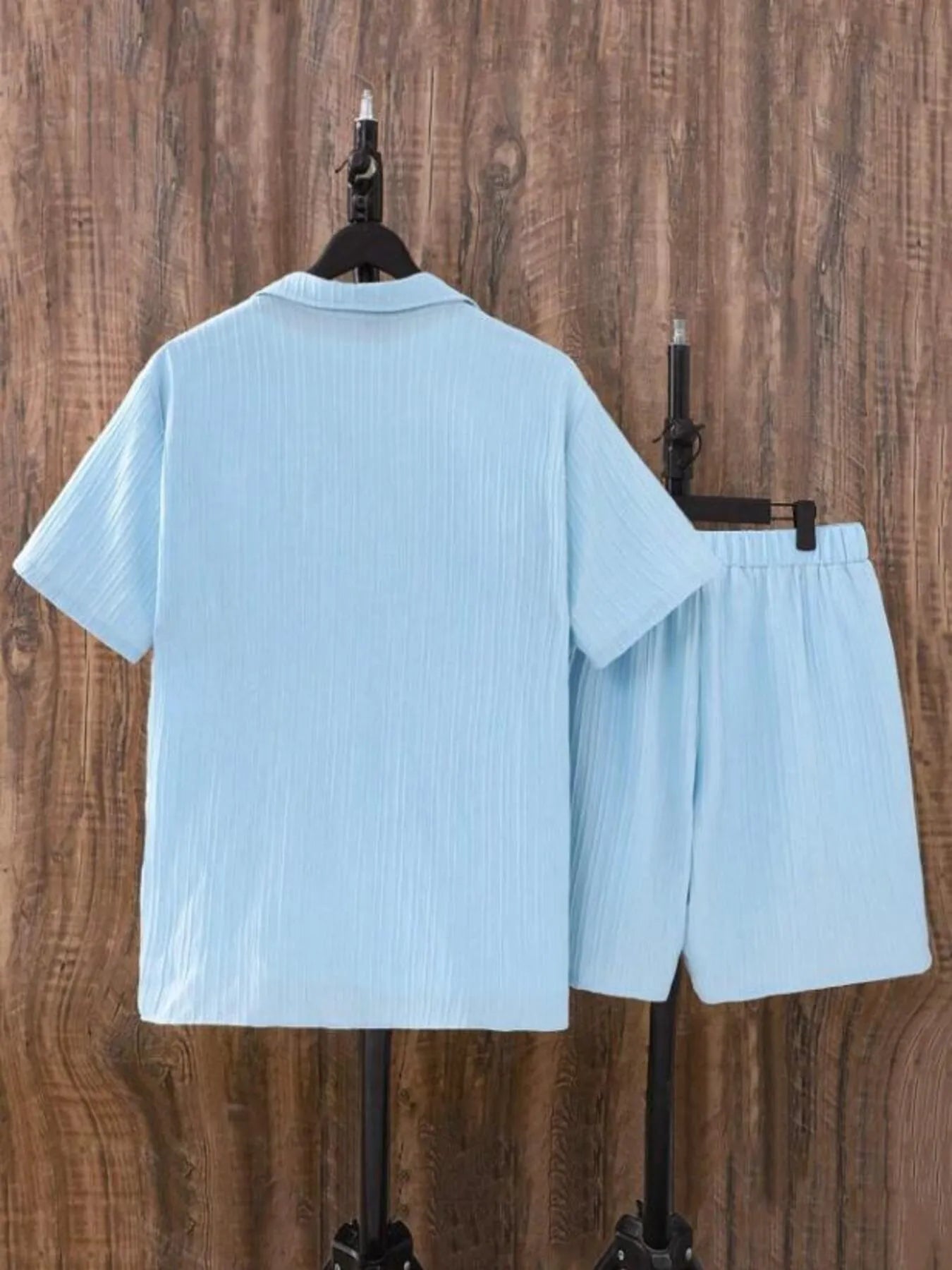 Back of men's plus size light blue short sleeve button-up shirt and matching shorts set