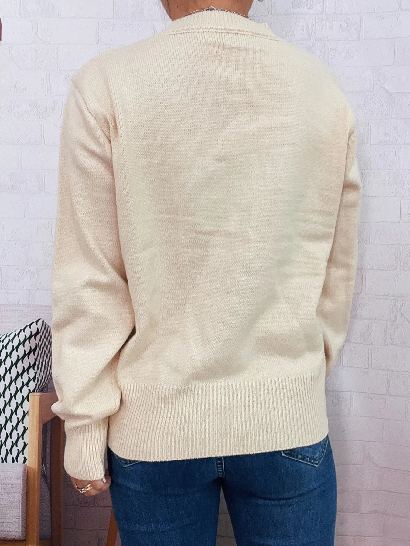 Cream knit cardigan sweater back view with ribbed hem and long sleeves