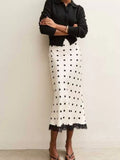 White midi skirt with black polka dots and lace trim at the hem