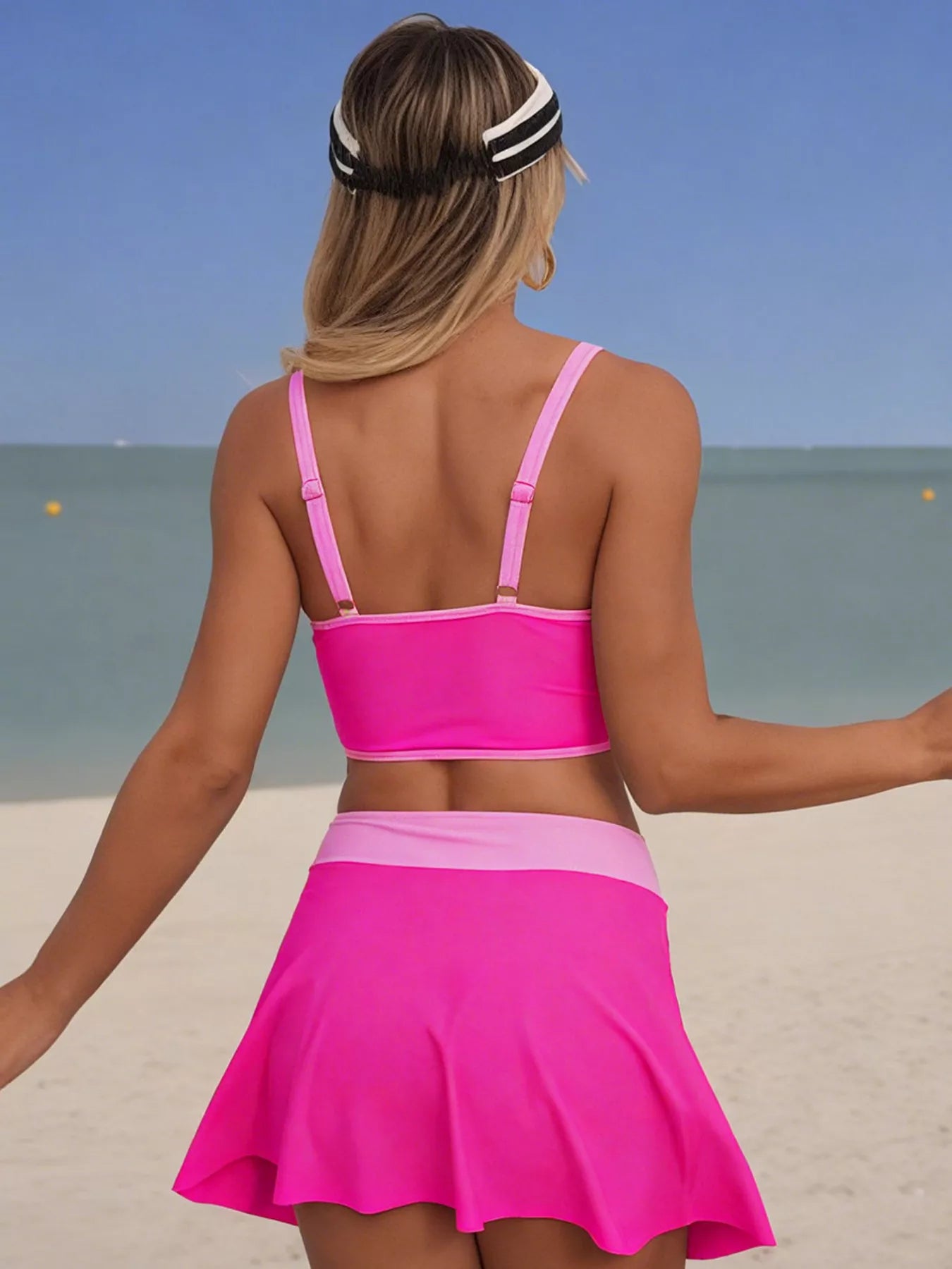 Two-piece pink swim set with contrast trim and a skirted bottom