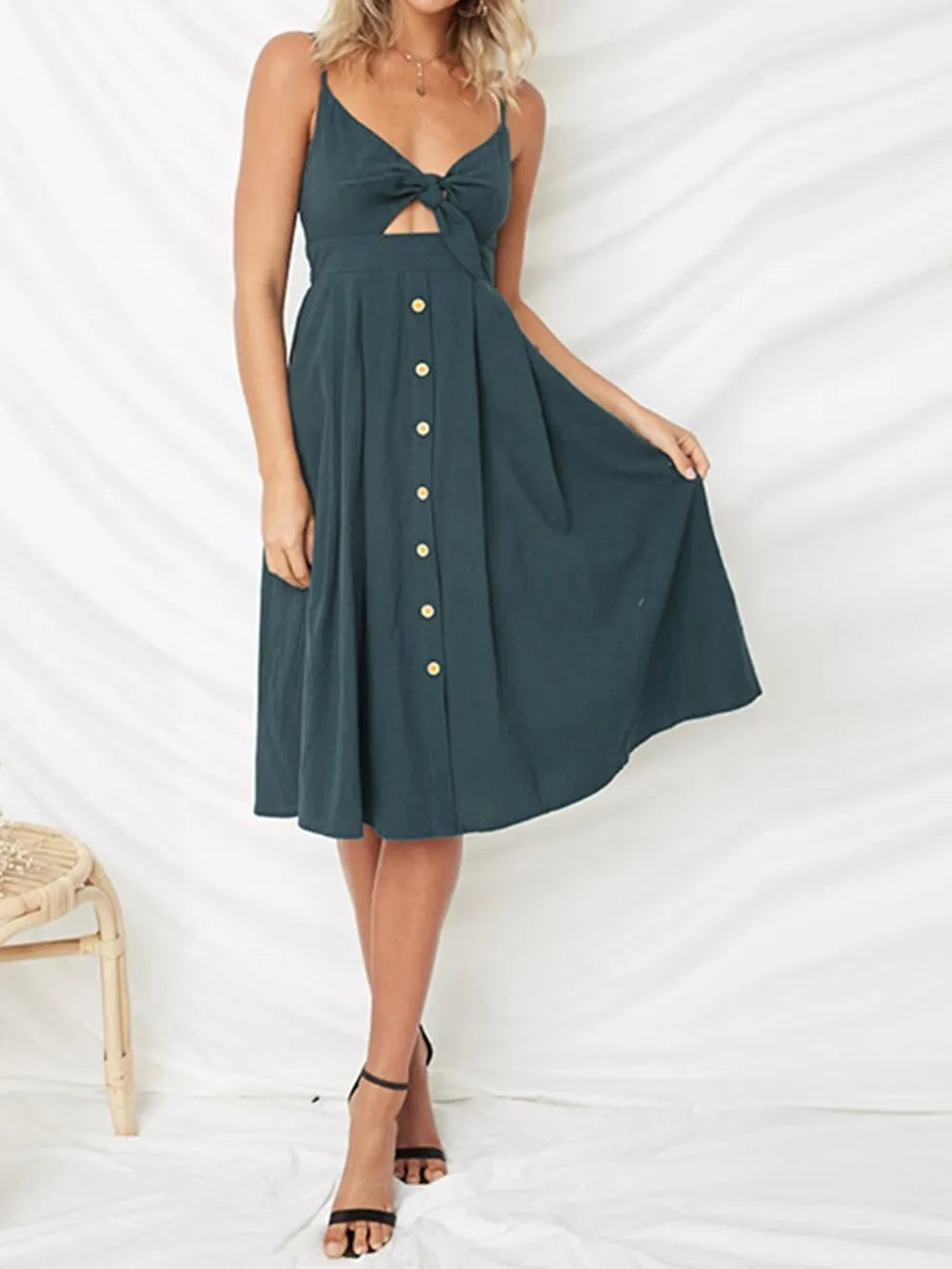 Dark teal cami dress with sweetheart cutout, bow tie front and gold button skirt