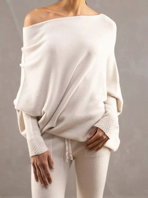 Cream boat-neck long-sleeve sweater with loose drape and side hem ties