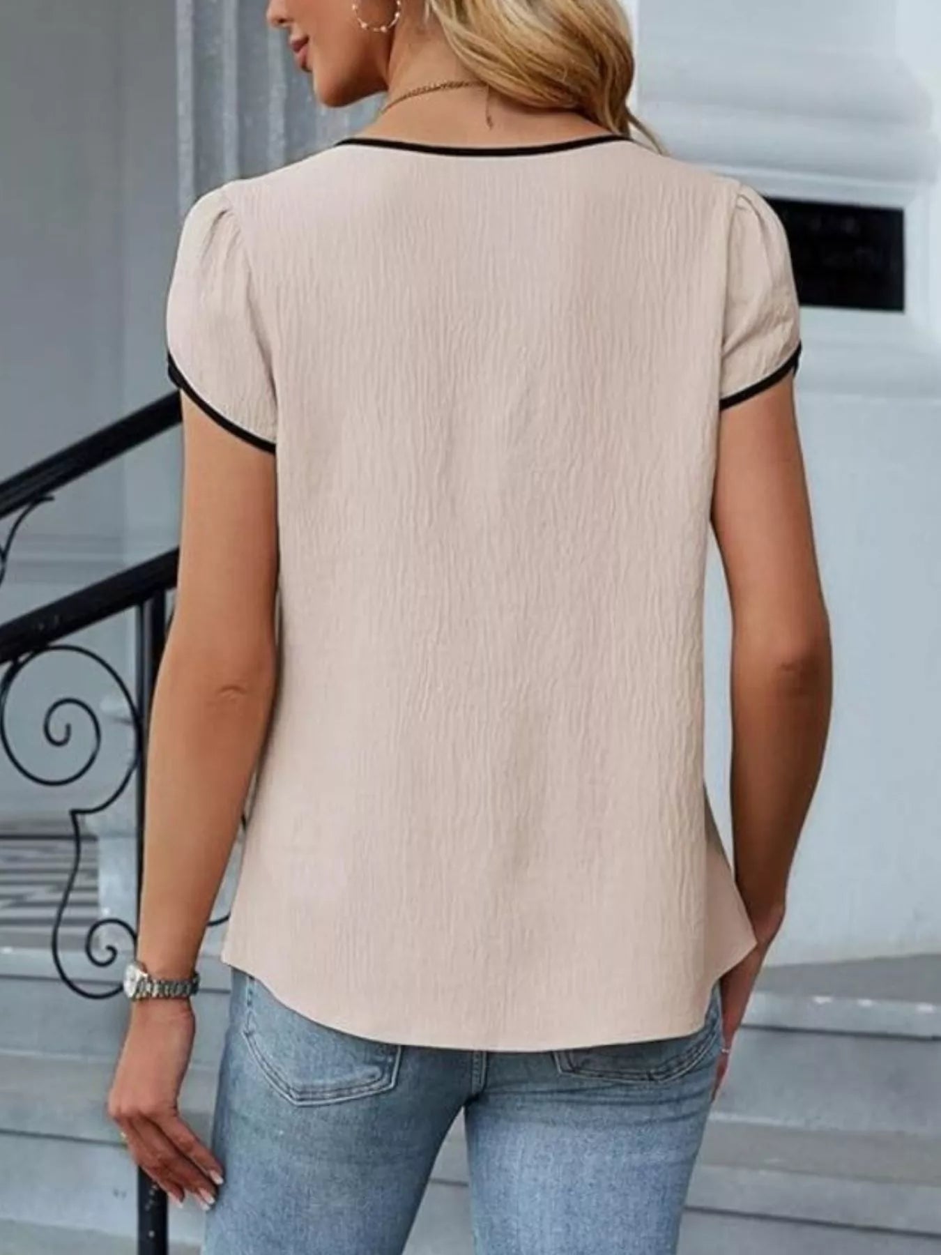 Notched Petal Sleeve Blouse in beige with black trim, back view, textured fabric