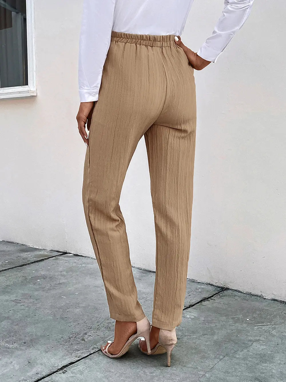 Tan textured drawstring pants with pockets, tapered ankle fit