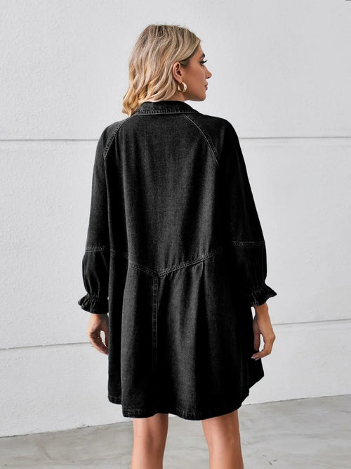 Back view: black denim mini dress with button detail and puff sleeves.