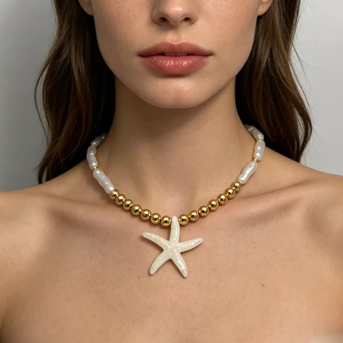 Gold-tone and pearl-look beaded necklace with white starfish pendant