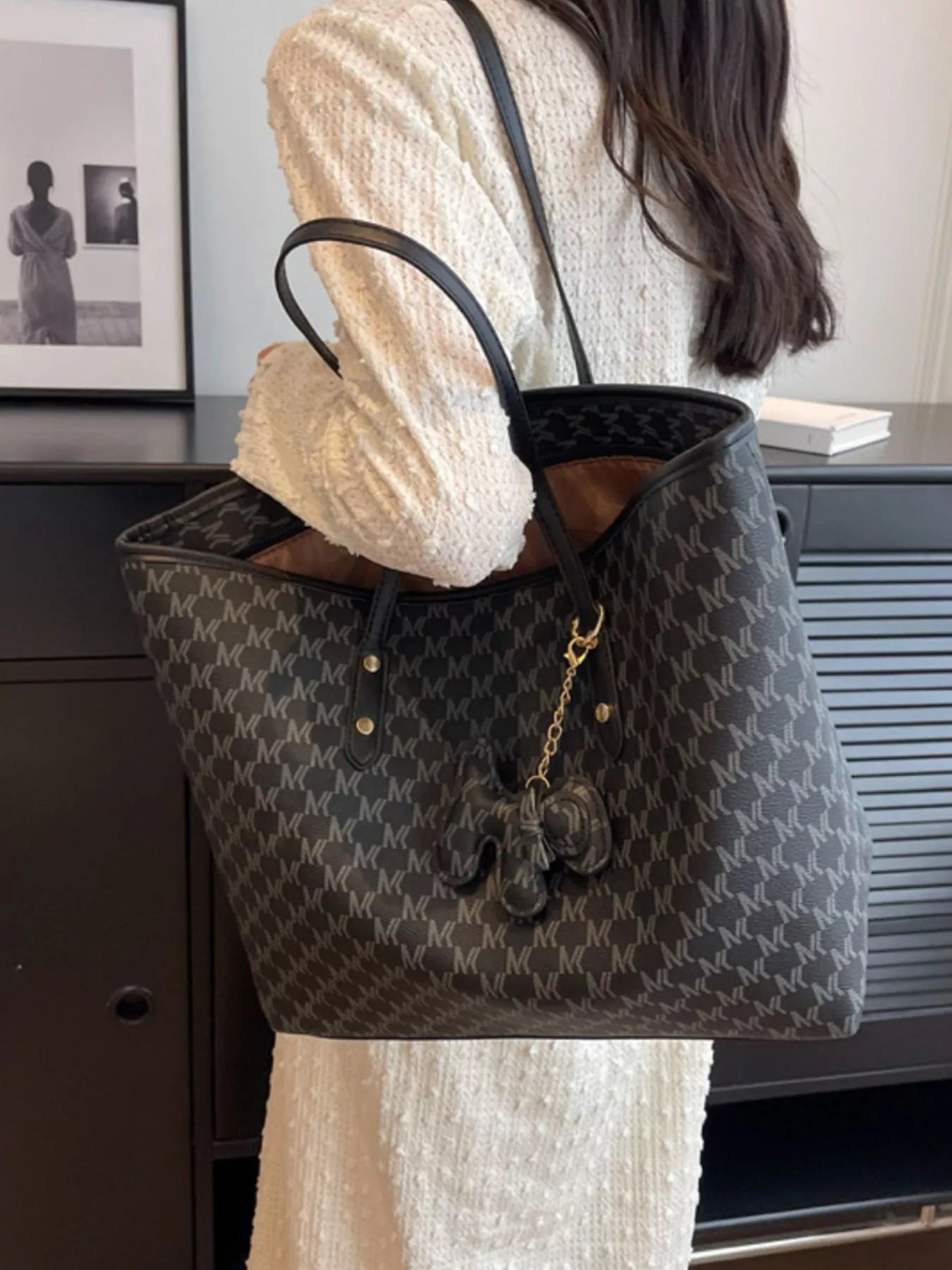 Medium dark monogram vegan leather tote with top handles and gold chain charm