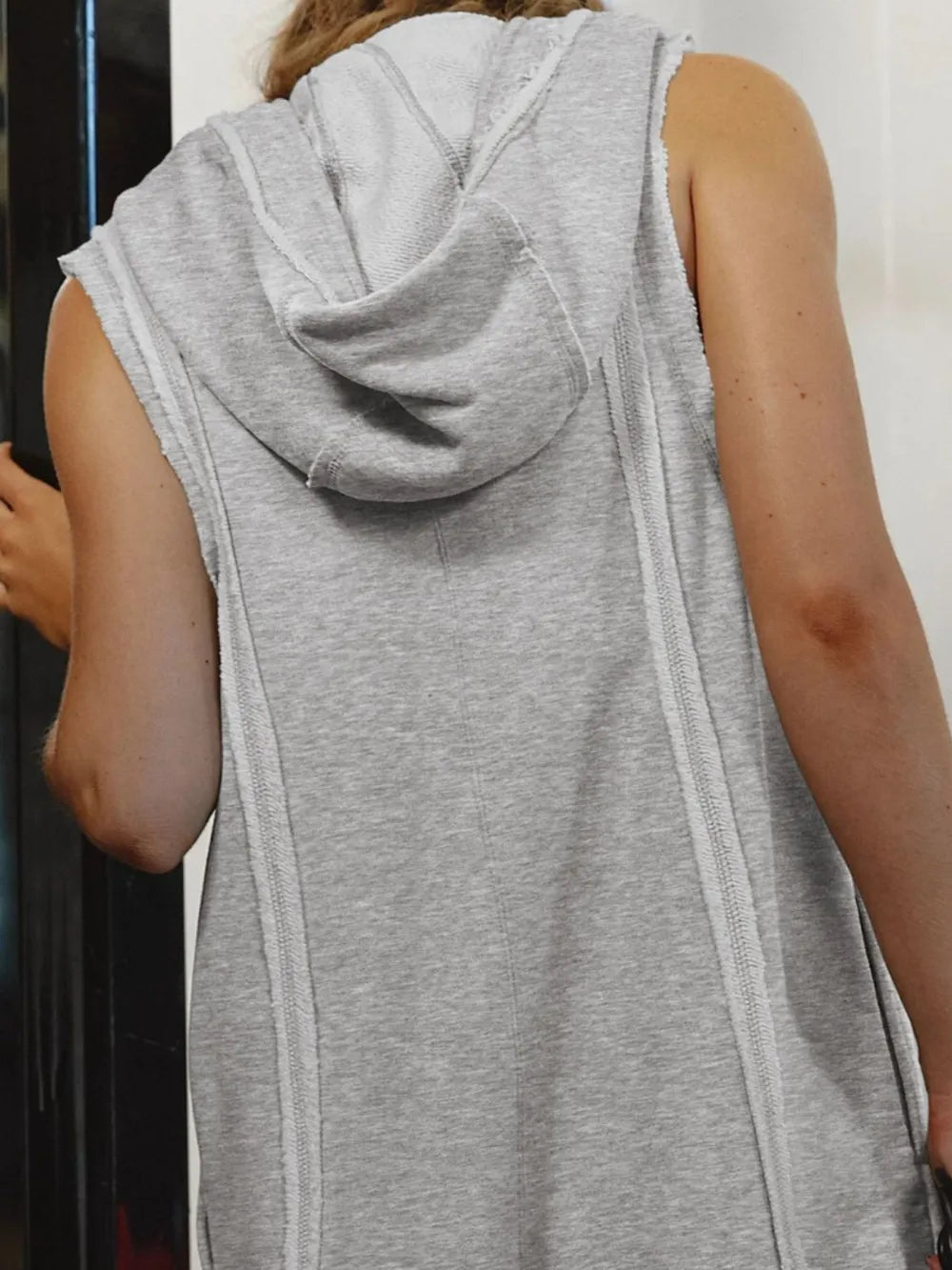 Gray hooded sleeveless romper back view with draped hood and visible seam details