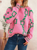 Pink long-sleeve sweater with green square pattern and ribbed round neckline and cuffs