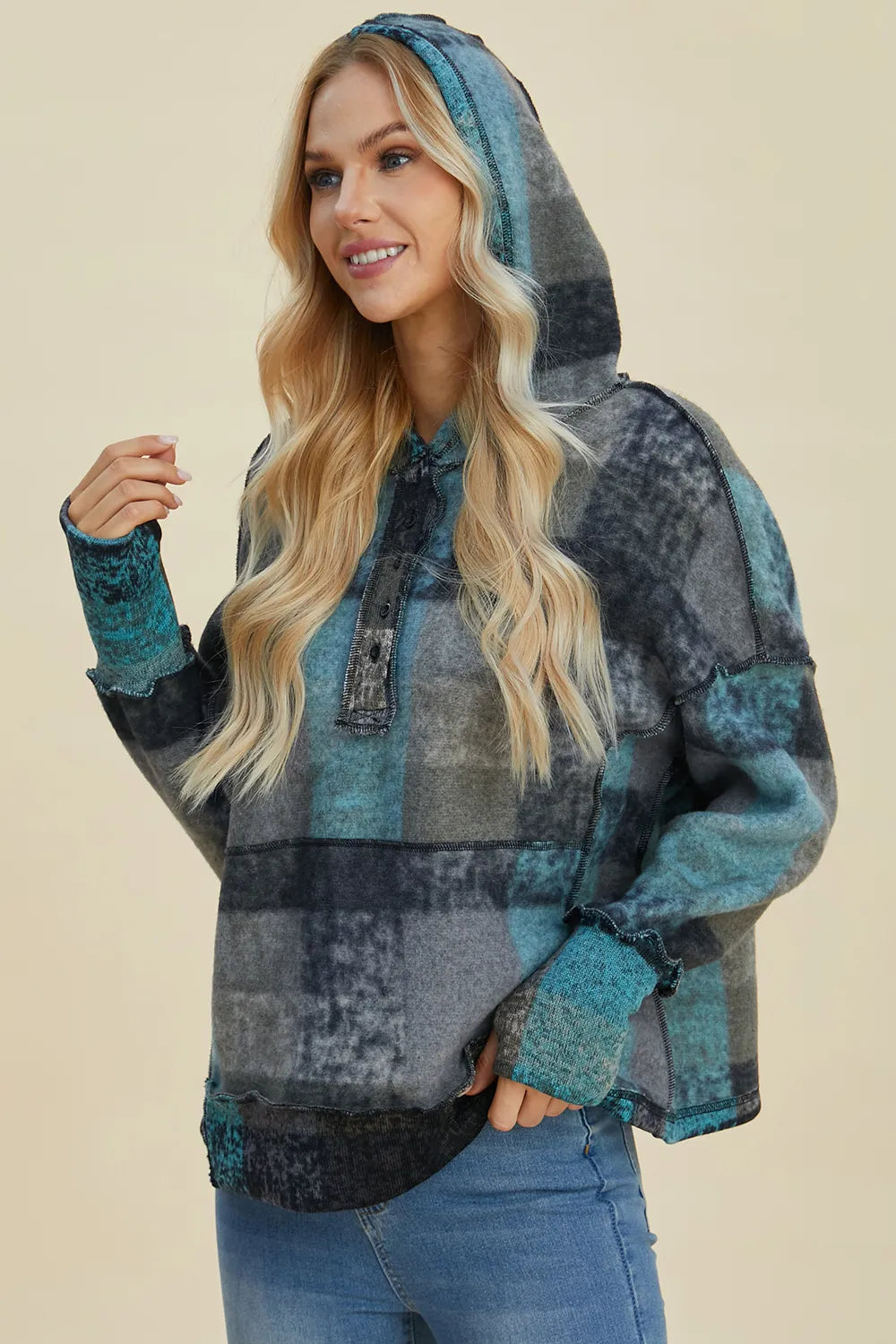 Multicolor plaid fleece hoodie with hood and half-zip placket, side profile view