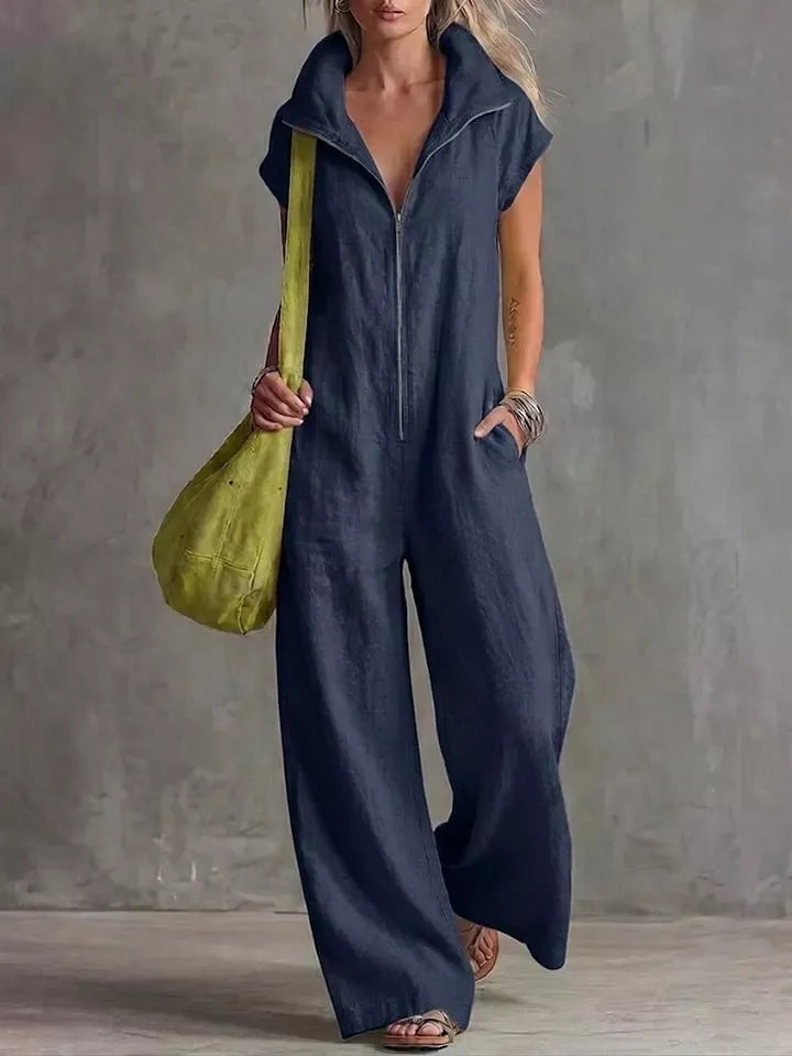 Navy blue sleeveless zip-front pocketed women’s jumpsuit with collared neckline and pockets