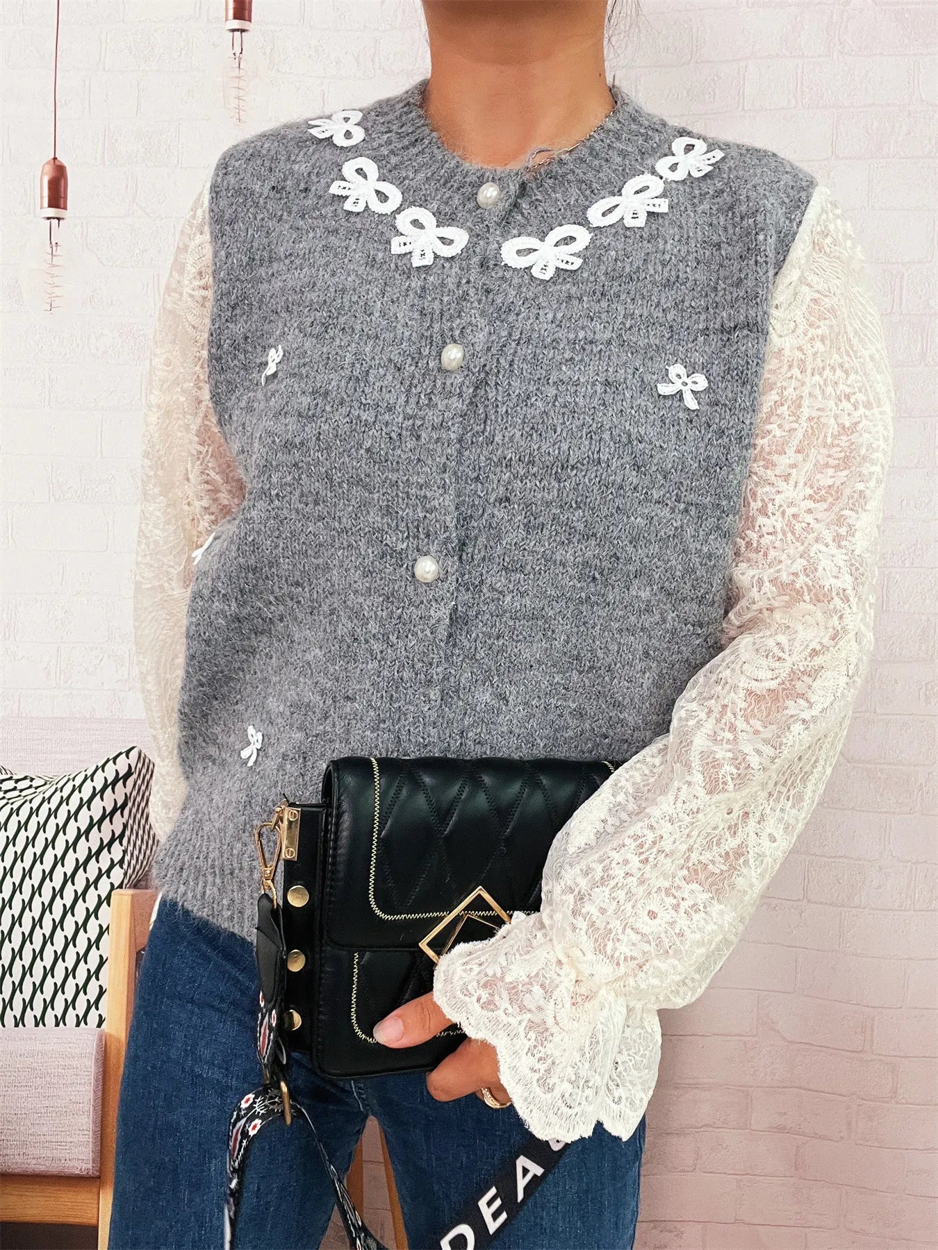 Gray knit button-up cardigan with lace sleeves and white bow appliques at neckline