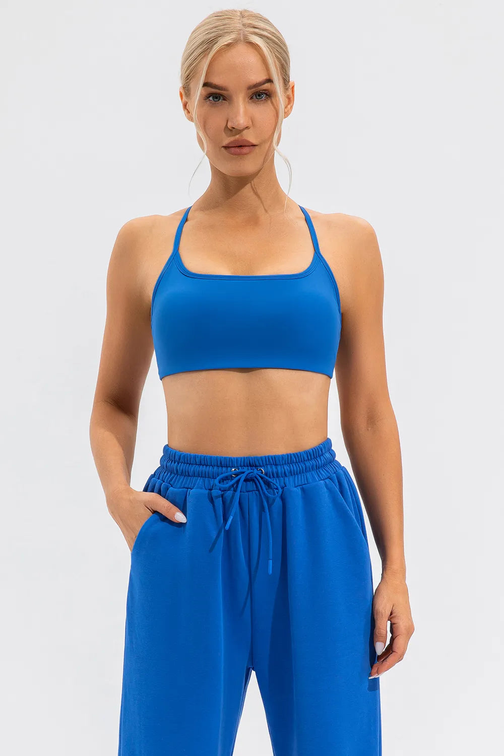 Blue active cami with square scoop neckline and thin spaghetti straps, cropped fit