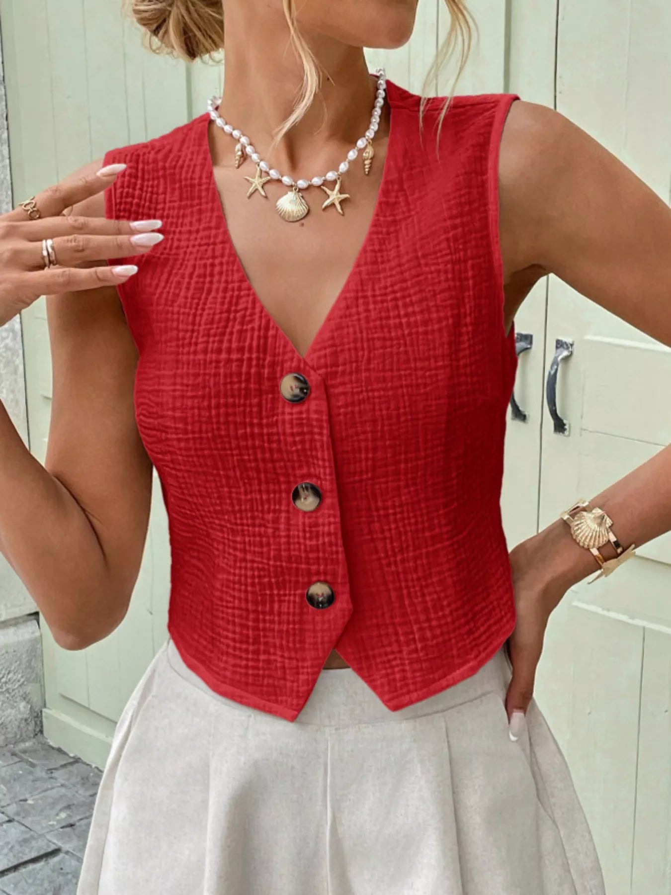 Red textured button-front vest with V-neck and dark buttons, sleeveless