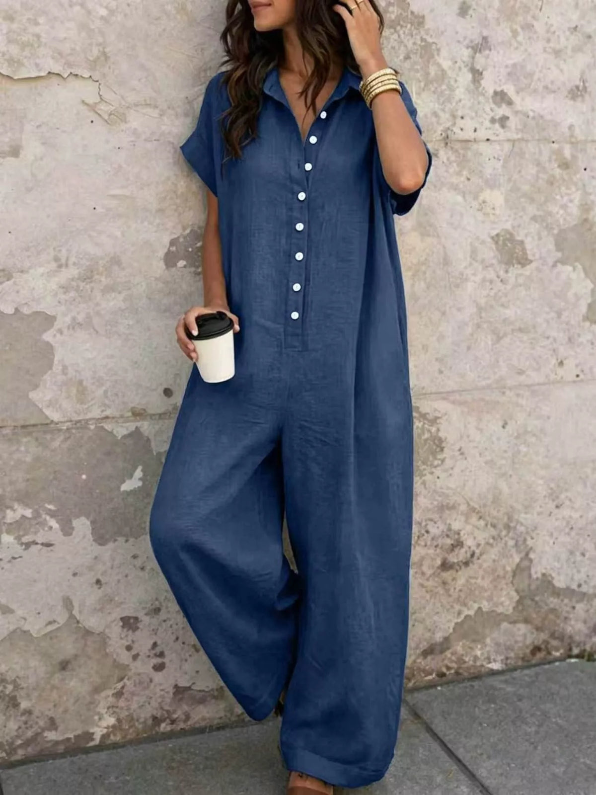 Dark blue button-front short-sleeve jumpsuit with wide legs and chest pockets