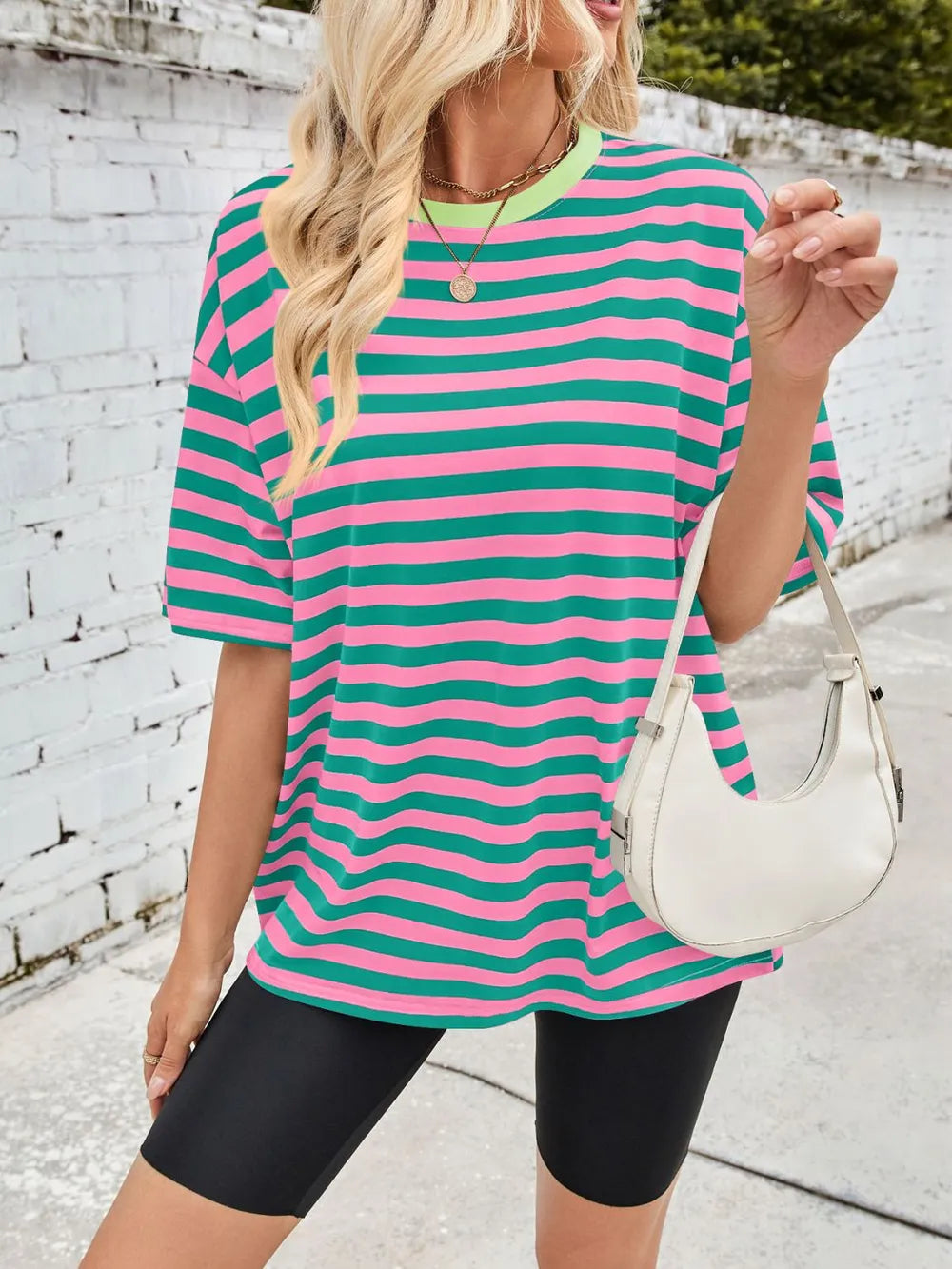 Green striped round-neck T-shirt with pink half sleeves, front side view