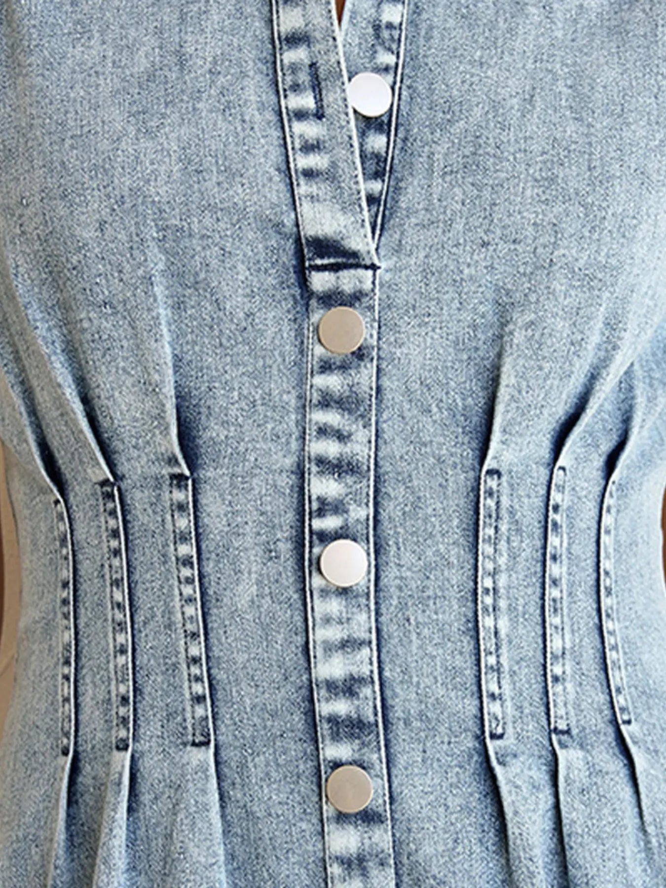 Denim button-front placket with large round buttons and pintuck detailing