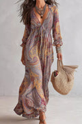 Paisley print smocked maxi dress with long sleeves, V-neck and flowing ankle-length skirt