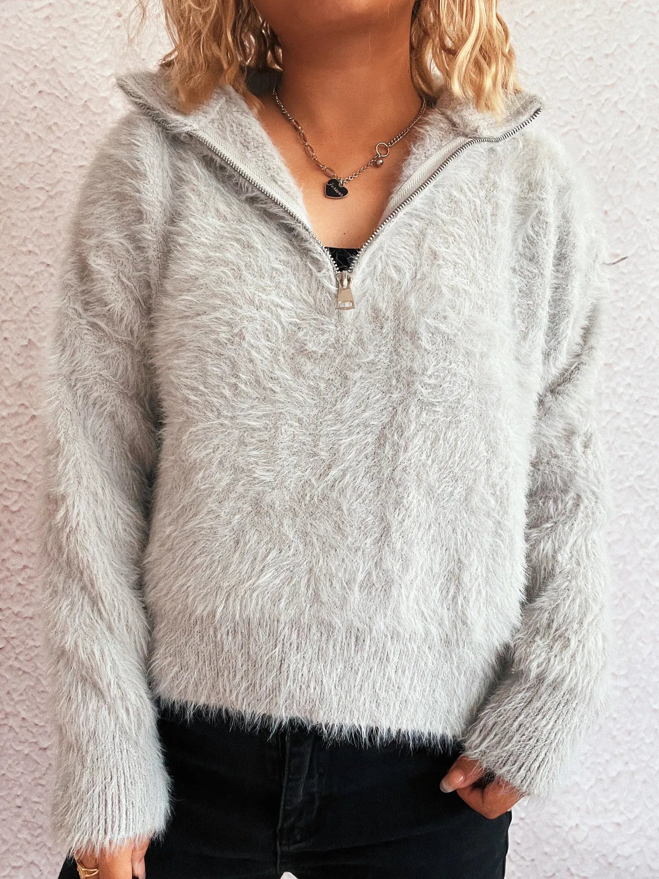 Grey fuzzy half-zip sweater with long sleeves and relaxed fit