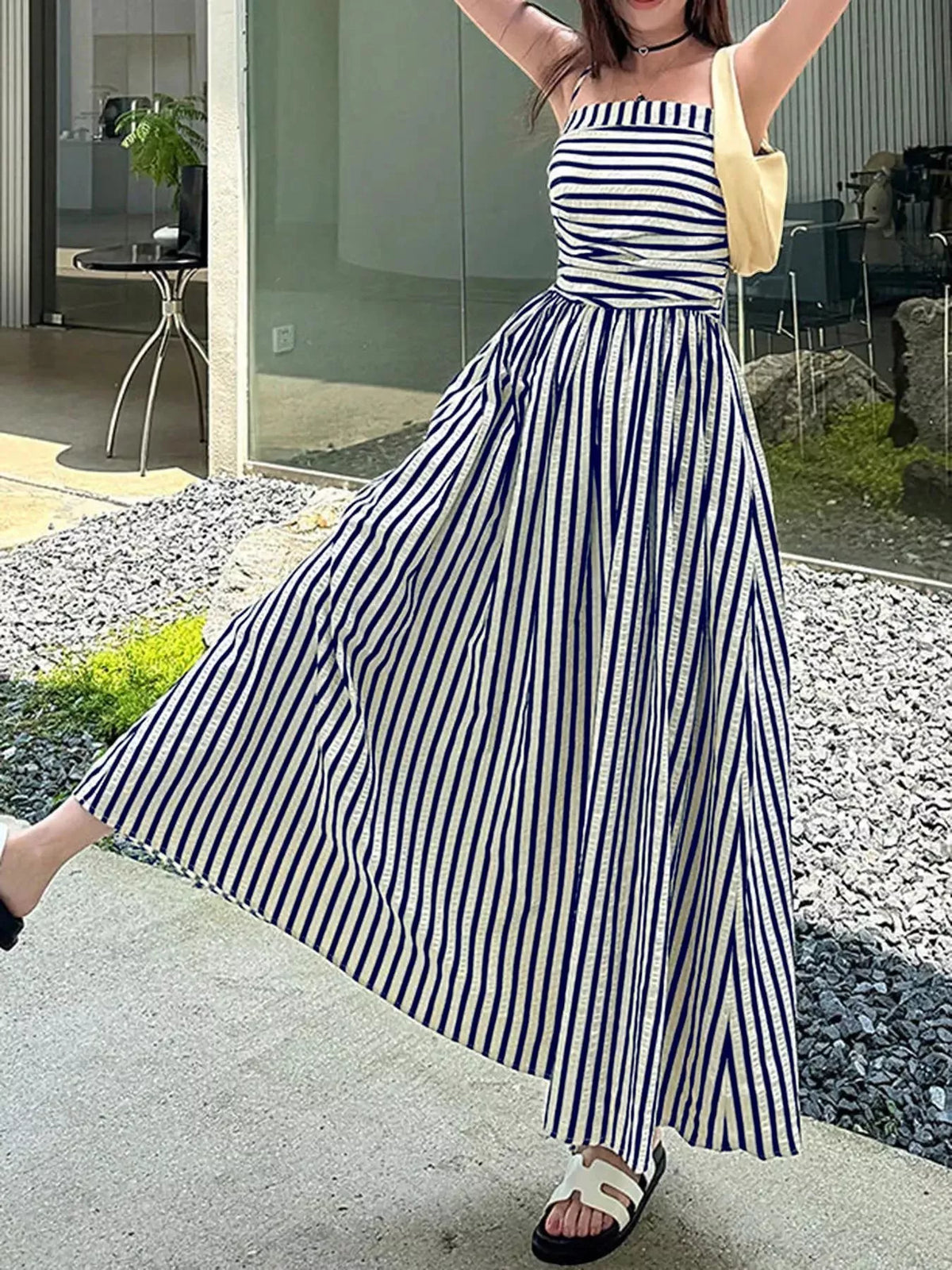 Ruched spaghetti-strap maxi dress with blue-and-white vertical stripes and gathered waist