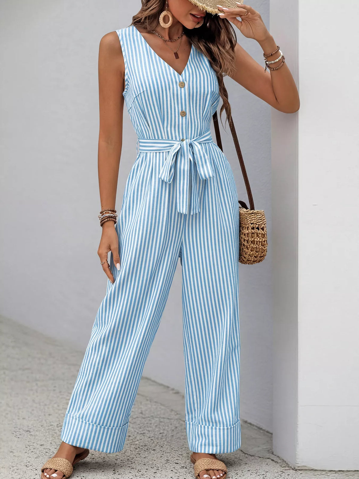 Striped sleeveless V-neck belted jumpsuit in light blue and white, button front, wide-leg