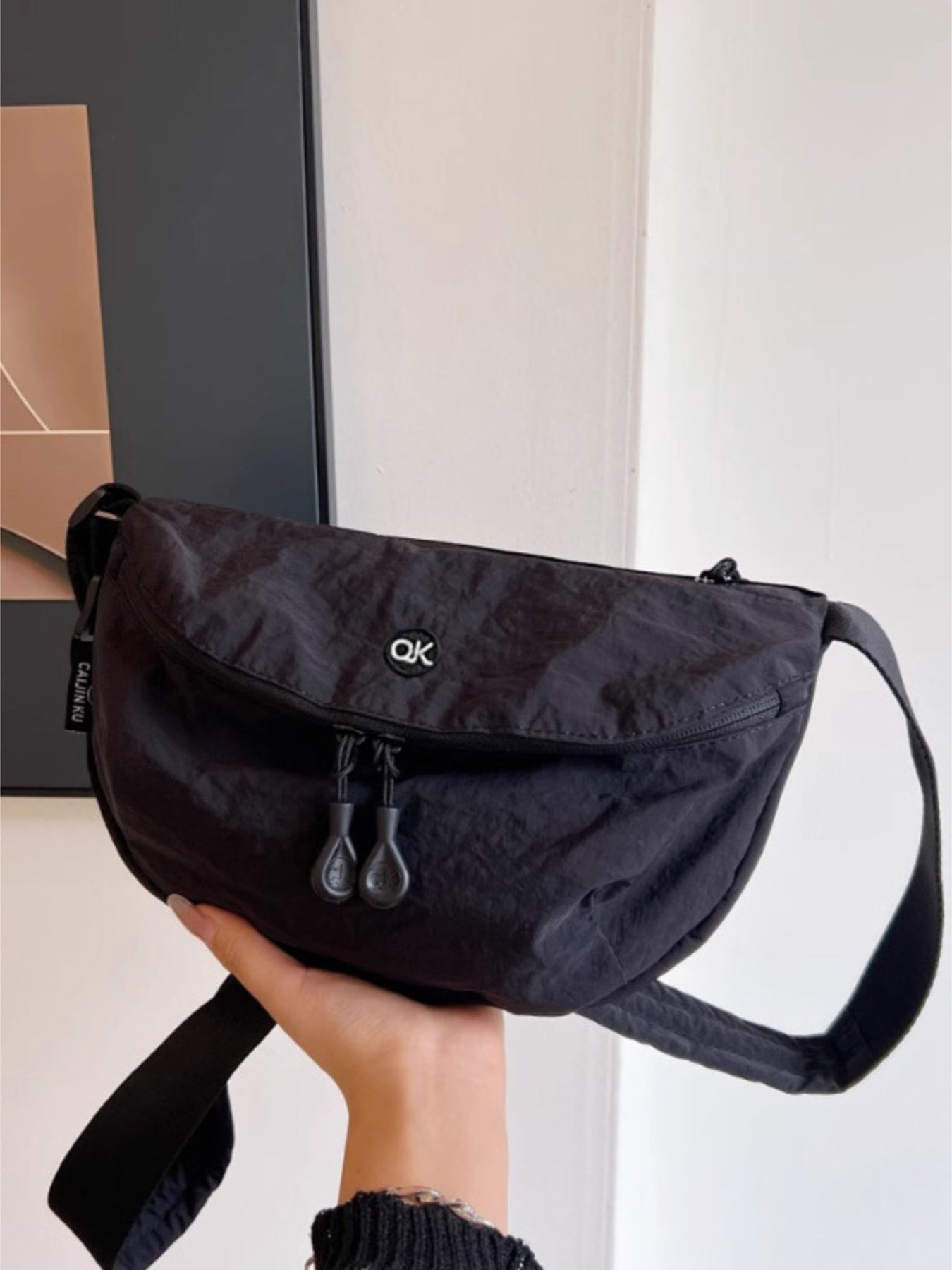 Lightweight nylon crossbody bag, medium, black with dual zip pulls and front pocket, OK logo badge