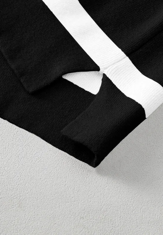 Hem and cuff close-up on contrast striped long sleeve sweatshirt, black with white stripes