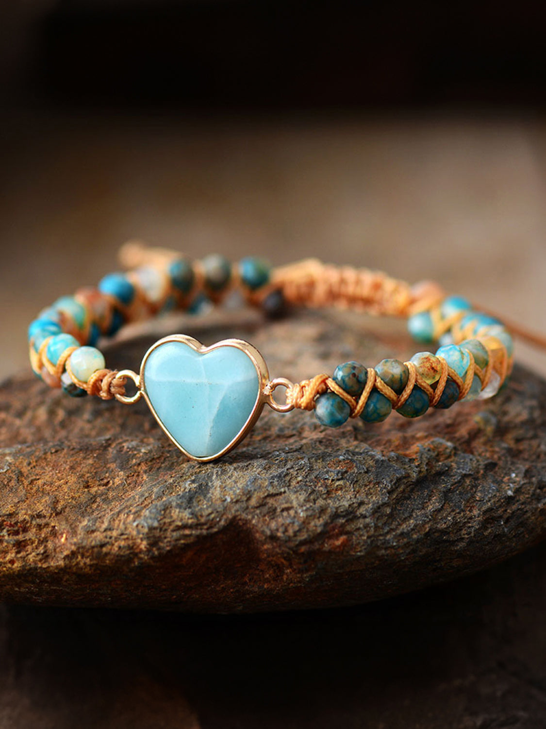Heart beaded bracelet featuring light blue heart charm with turquoise and orange braided beads