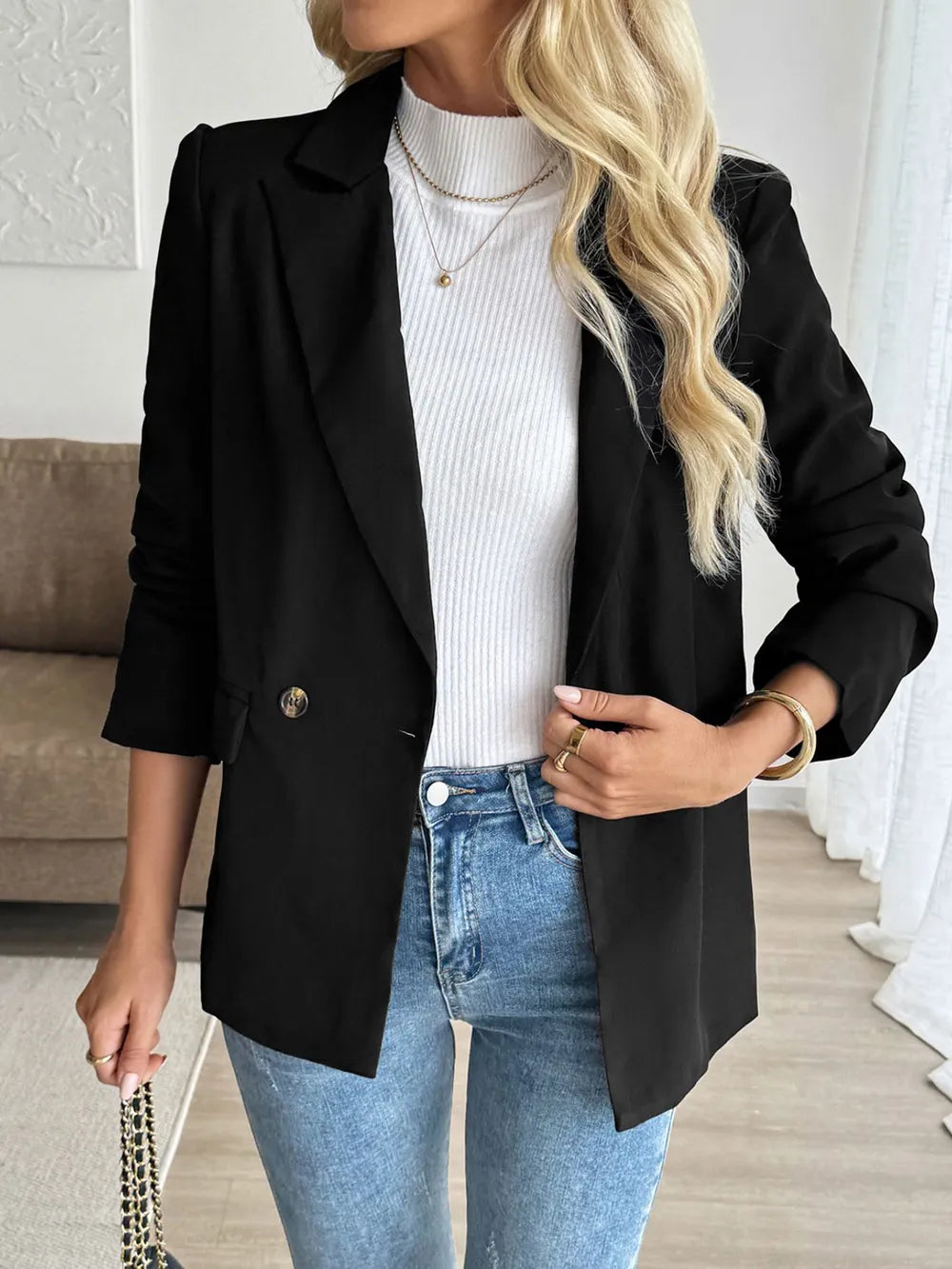 Black lapel-collar blazer with structured shoulders and side pockets