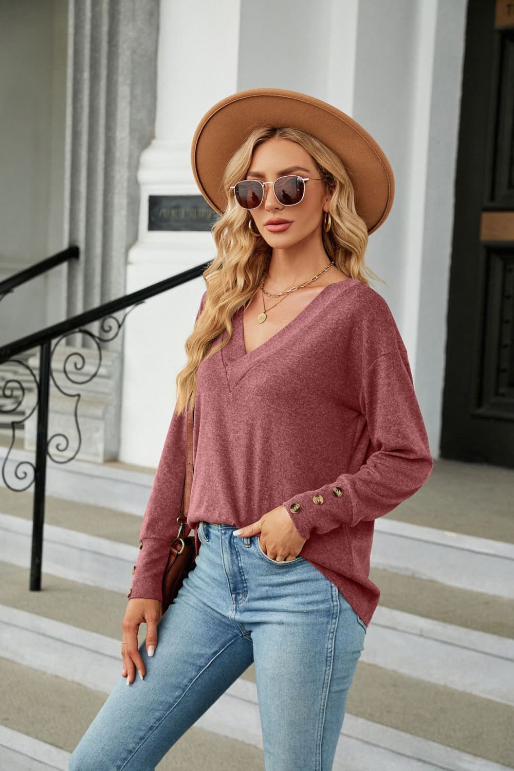 Cedar & Moore V-Neck long sleeve mauve solid knit top with buttoned cuffs on model wearing denim jeans