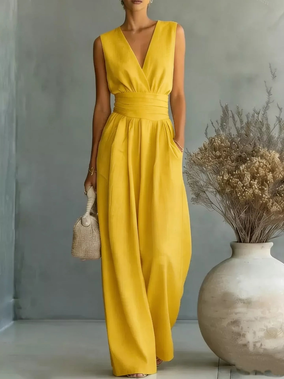 Yellow sleeveless wide-leg jumpsuit with V-neck wrap bodice and gathered waist