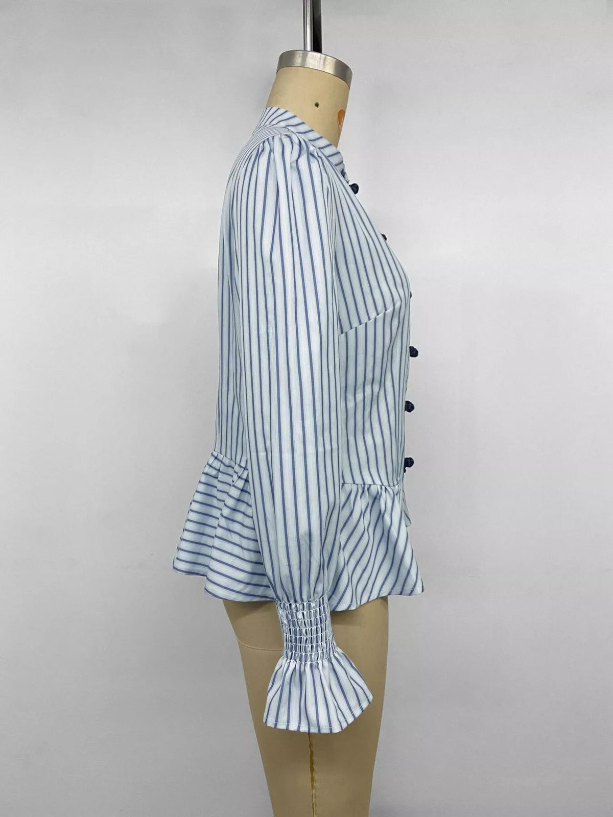 Blue striped mandarin peplum knot shirt, side view with puff sleeves