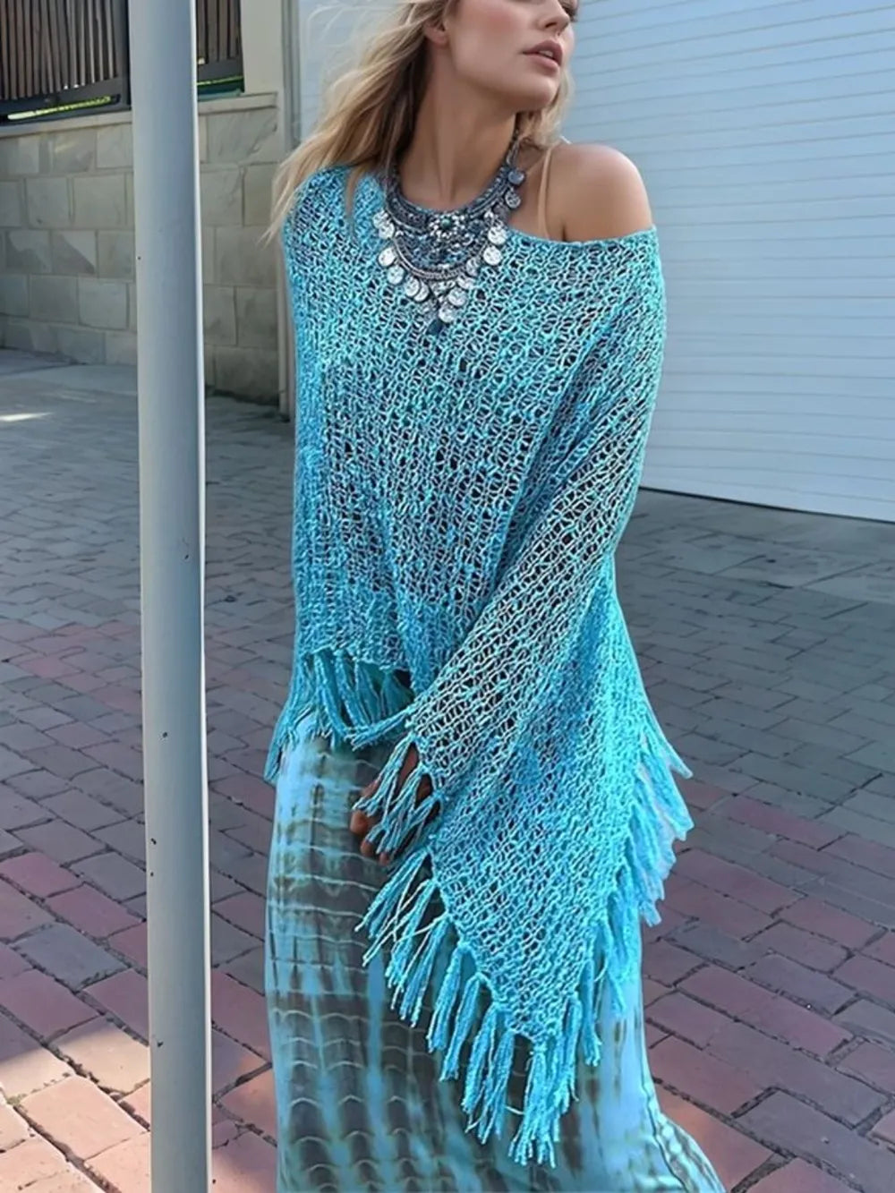 Sky blue open-knit shawl with off-shoulder style and fringe tassels