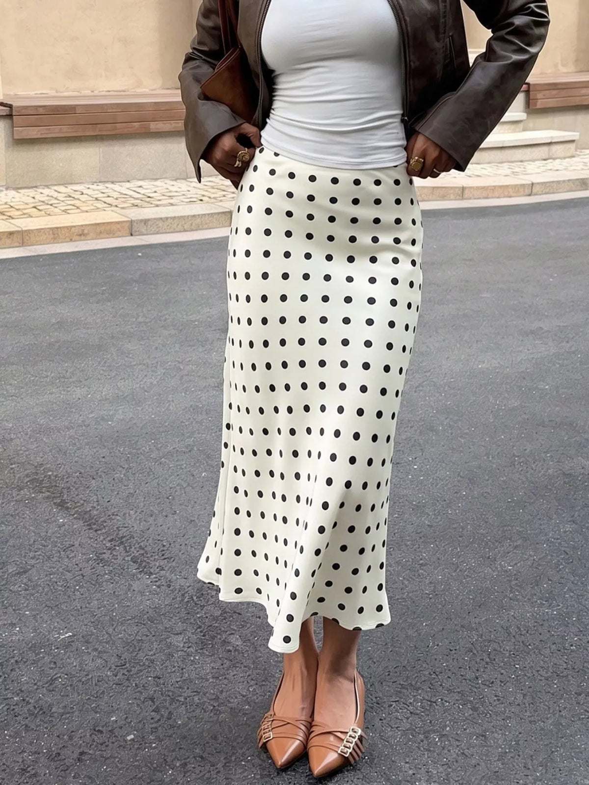Beige polka dot stretch midi skirt, side view with long flared hem