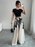 White and black floral printed wide-leg pants with bow-tied drawstring, side view