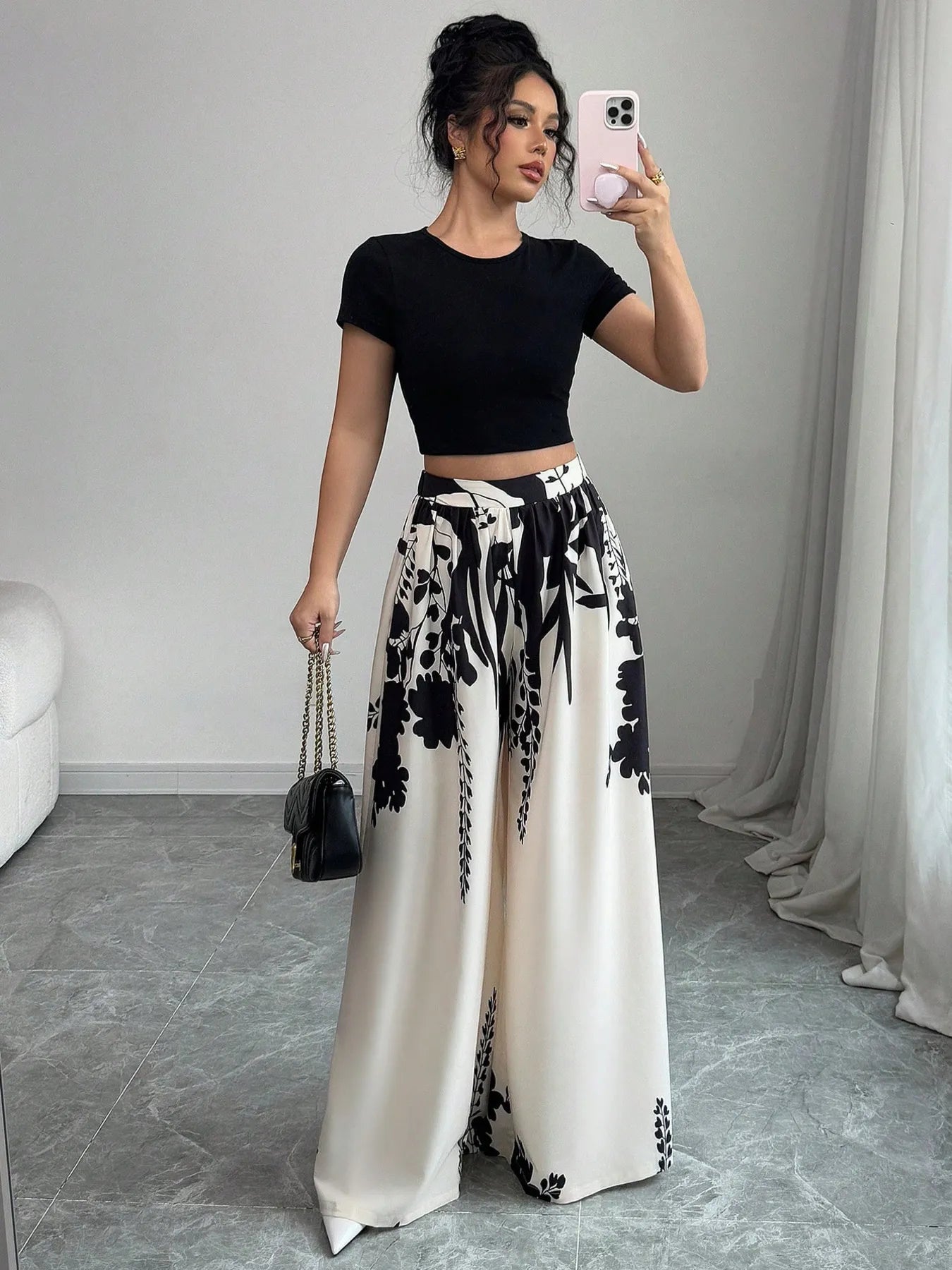 White and black floral printed wide-leg pants with bow-tied drawstring, side view
