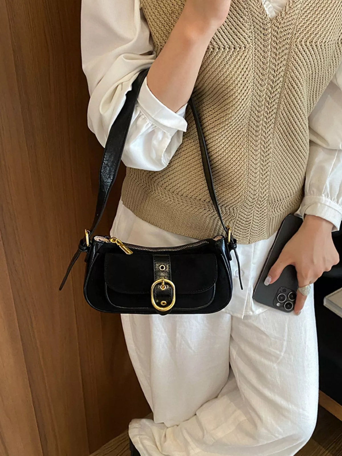 Black suede crossbody shoulder bag with flap, buckle clasp, and adjustable strap