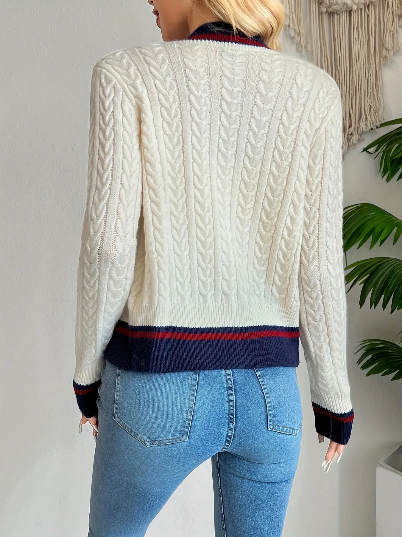 Ivory cable-knit cardigan back with navy and red striped hem and cuffs