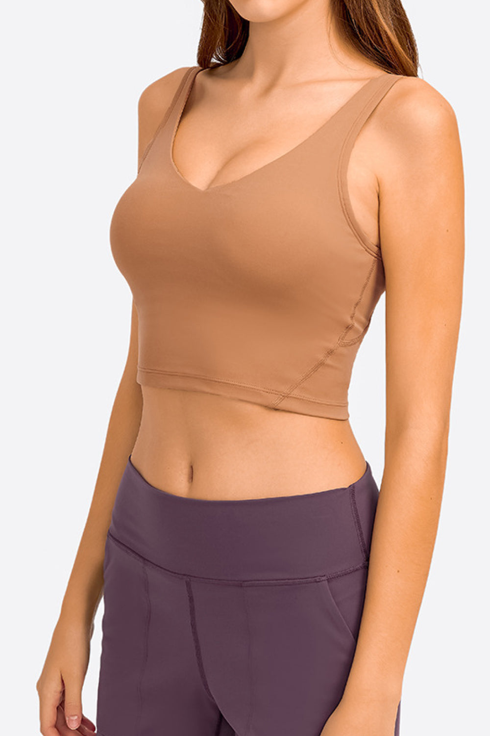 Tan deep V-neck crop sports bra with supportive seams