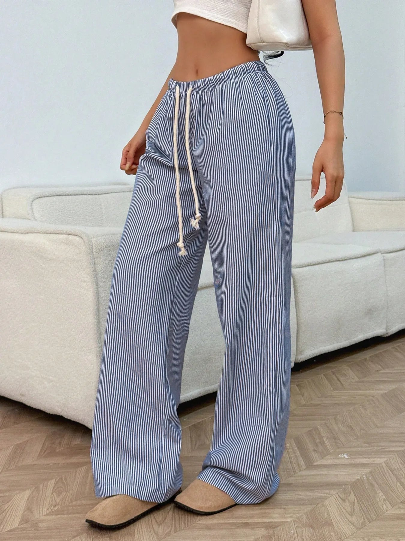 Light blue striped wide-leg pants with drawstring waist and relaxed loose fit