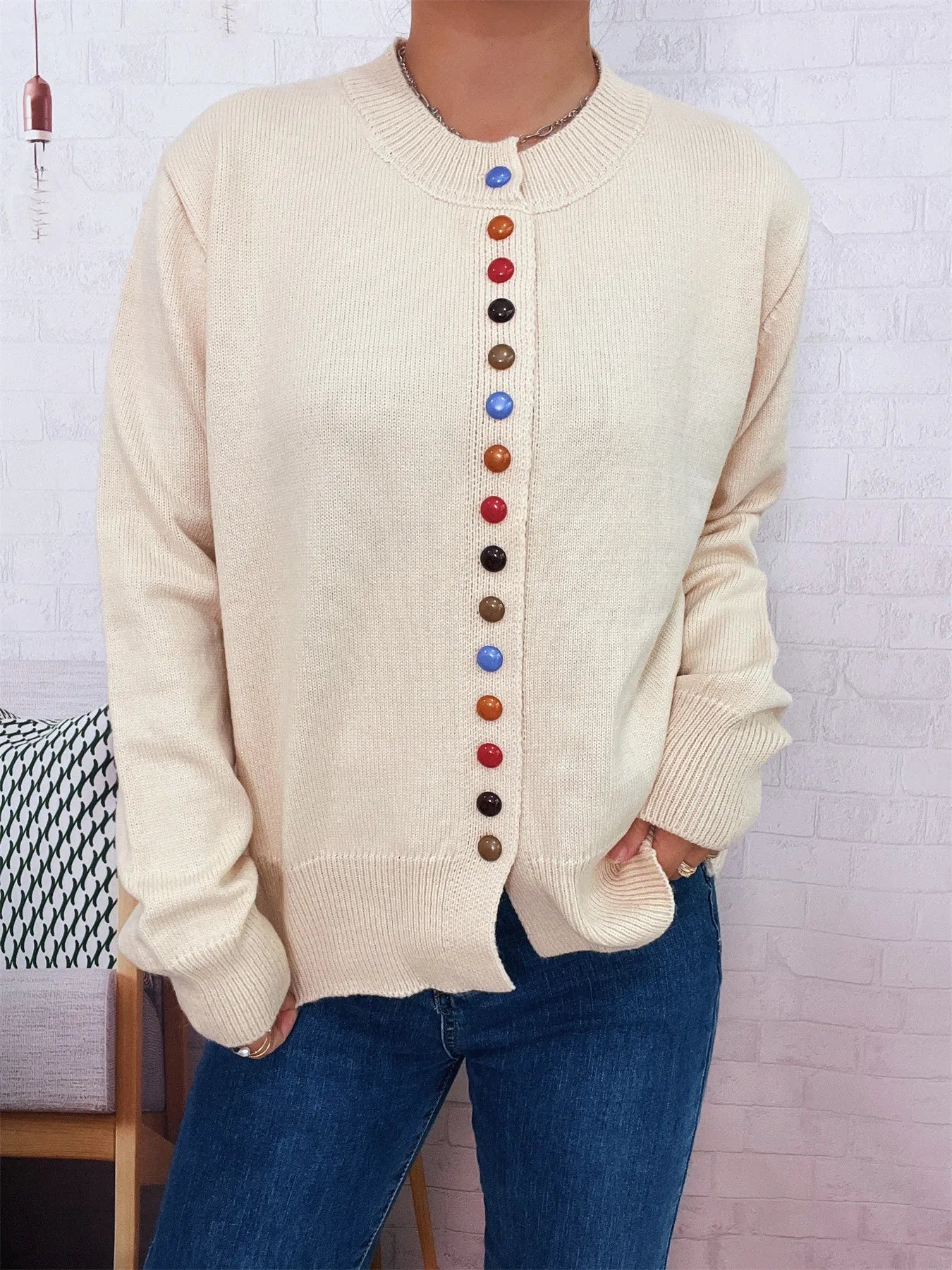 Cream knit cardigan with crew neck and multicolor button placket