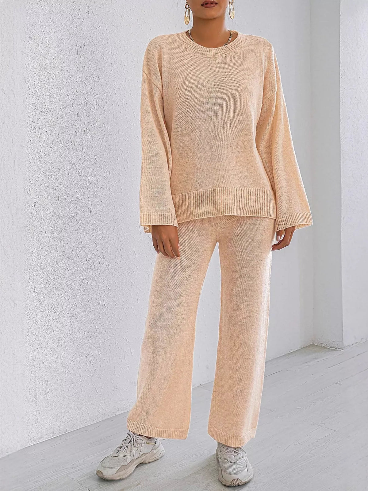 Apricot knit sweater and pants set featuring dropped shoulders, crew neck, and ribbed trim.
