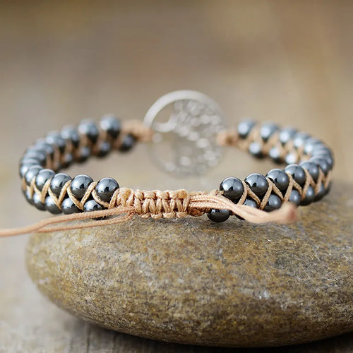 Gray braided bead bracelet with round tree-of-life charm and cord loop bead spacer