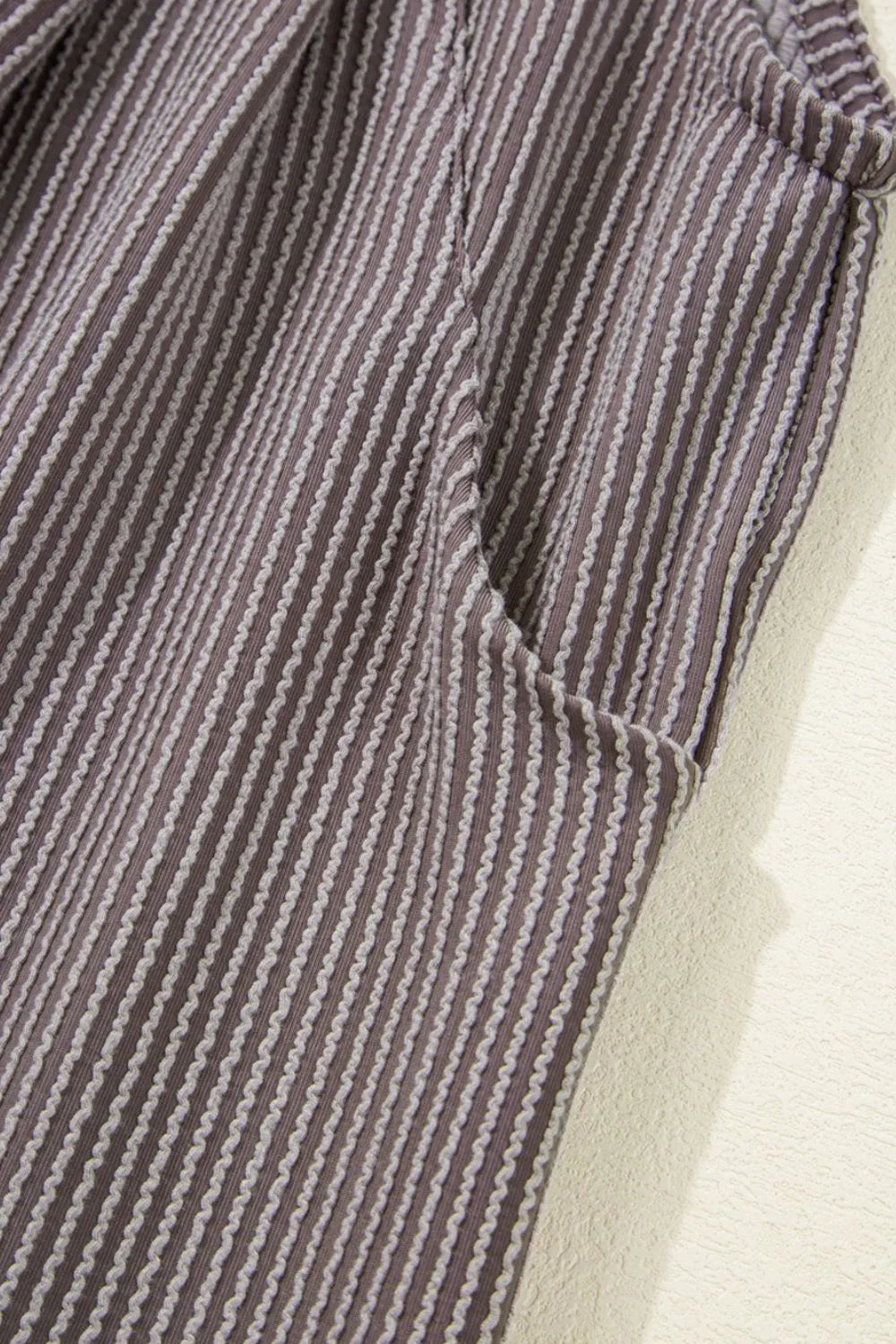 Pinstriped overalls with front pocket and vertical seam stitching