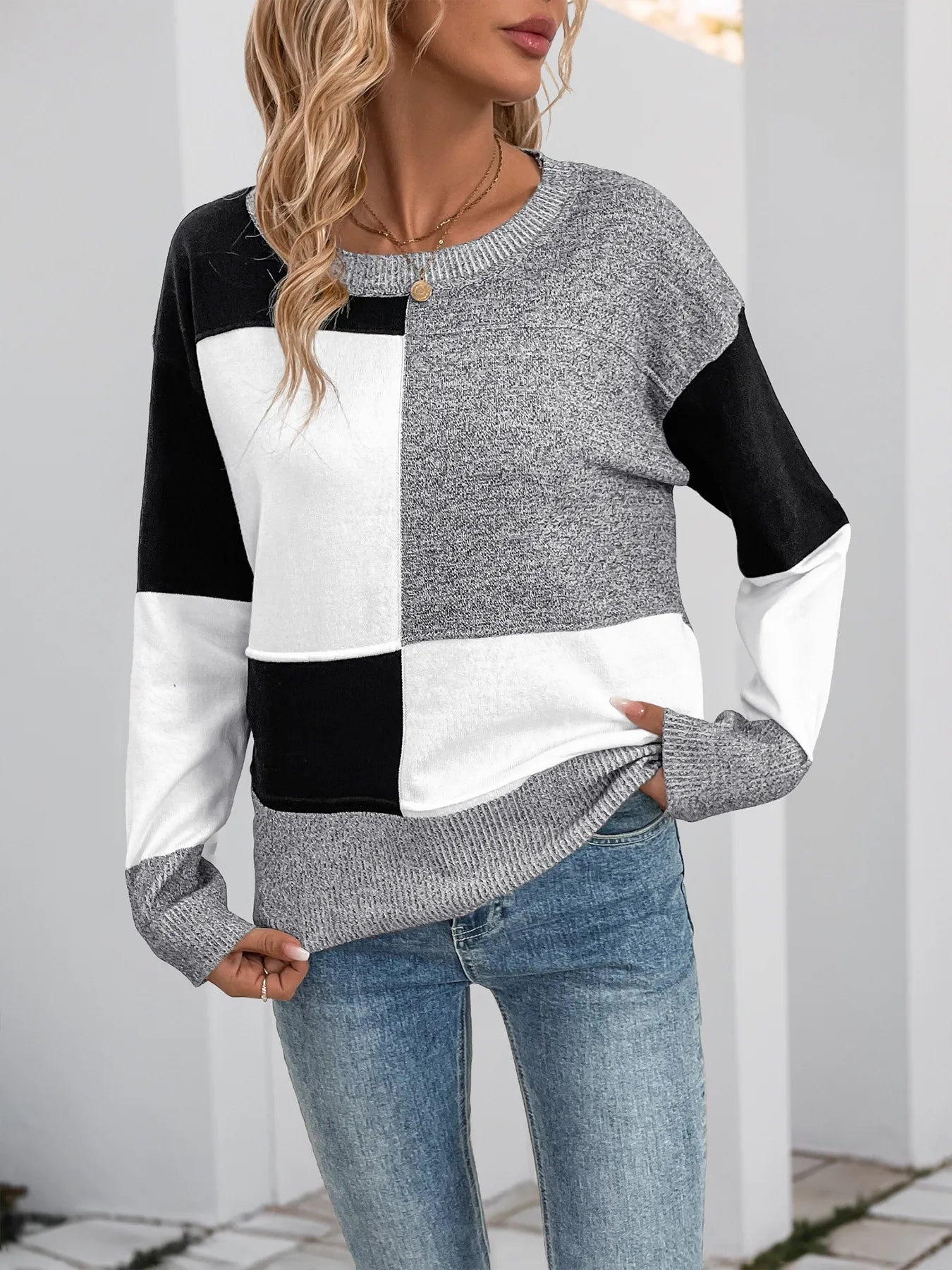 Grey color-block long-sleeve knit sweater with black and white paneling and ribbed cuffs