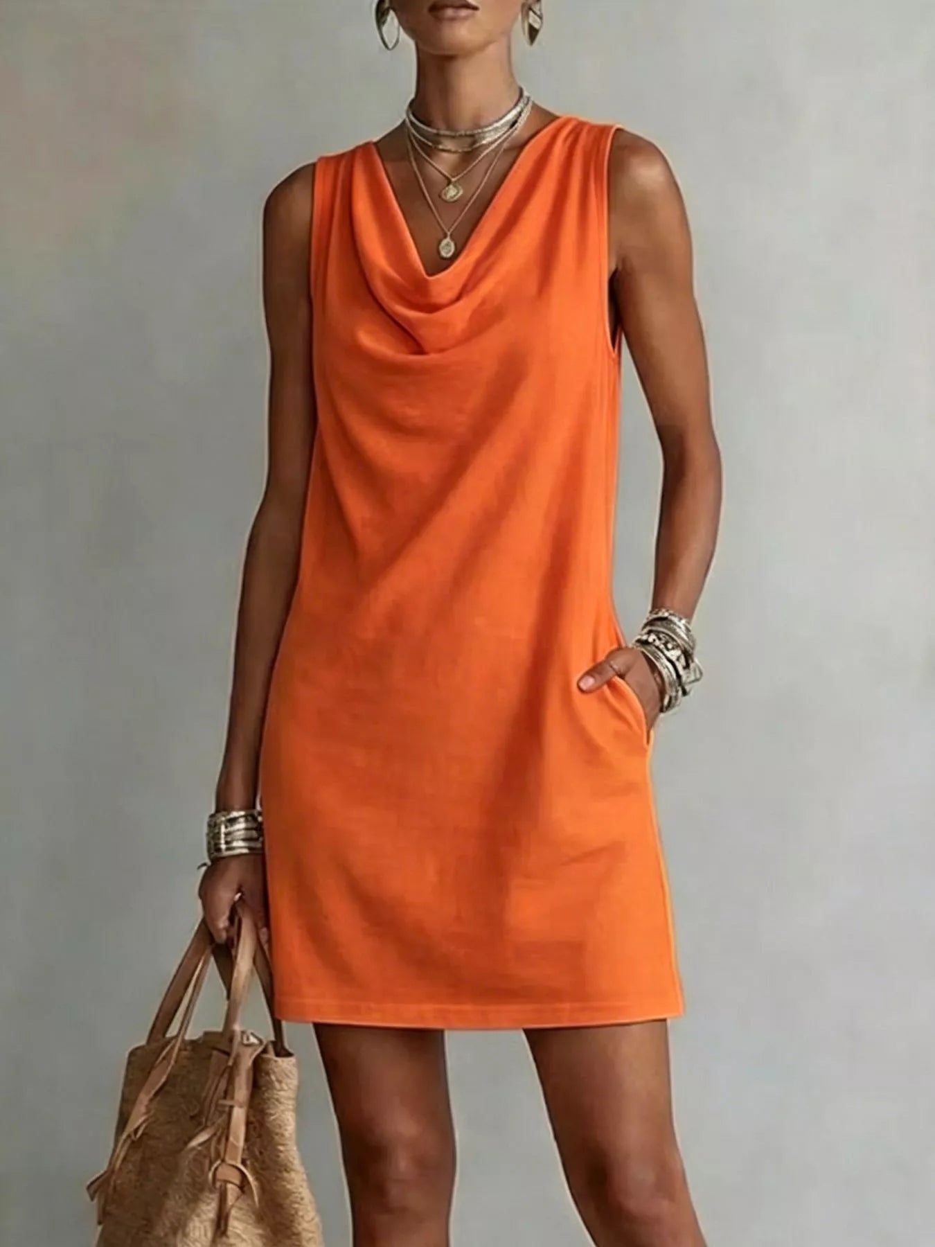 Orange sleeveless cowl-neck mini dress with draped neckline and straight hem.