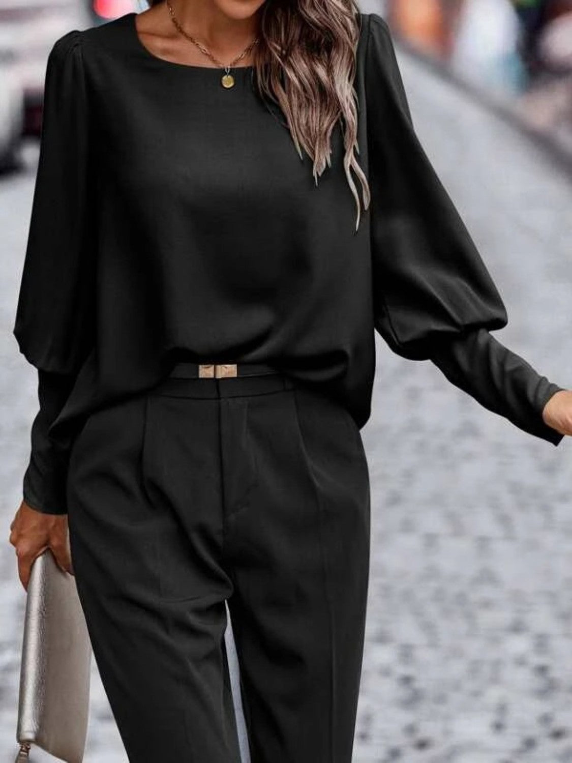 Black lantern-sleeve blouse with round neckline and gathered puff sleeves