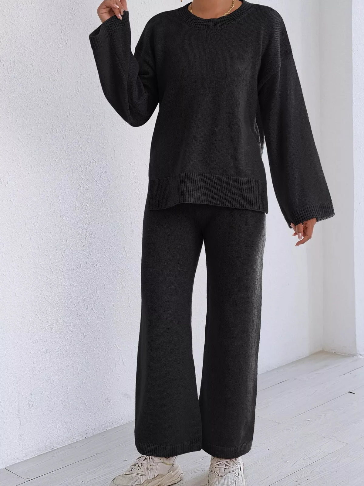 Black dropped-shoulder knit sweater and wide-leg pants set, crew neckline