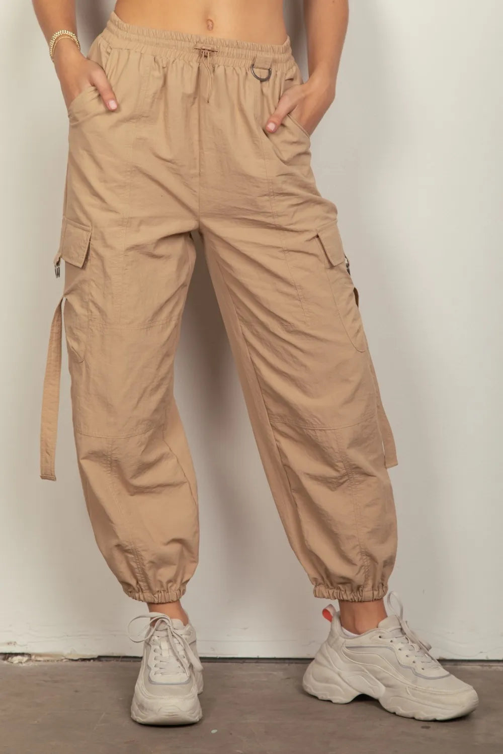 Taupe elastic waist cargo pants with side pockets and drawstring jogger cuffs