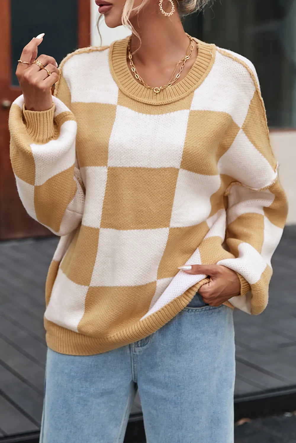 Tan and white checkered drop-shoulder sweater with ribbed crew neck and cuffs